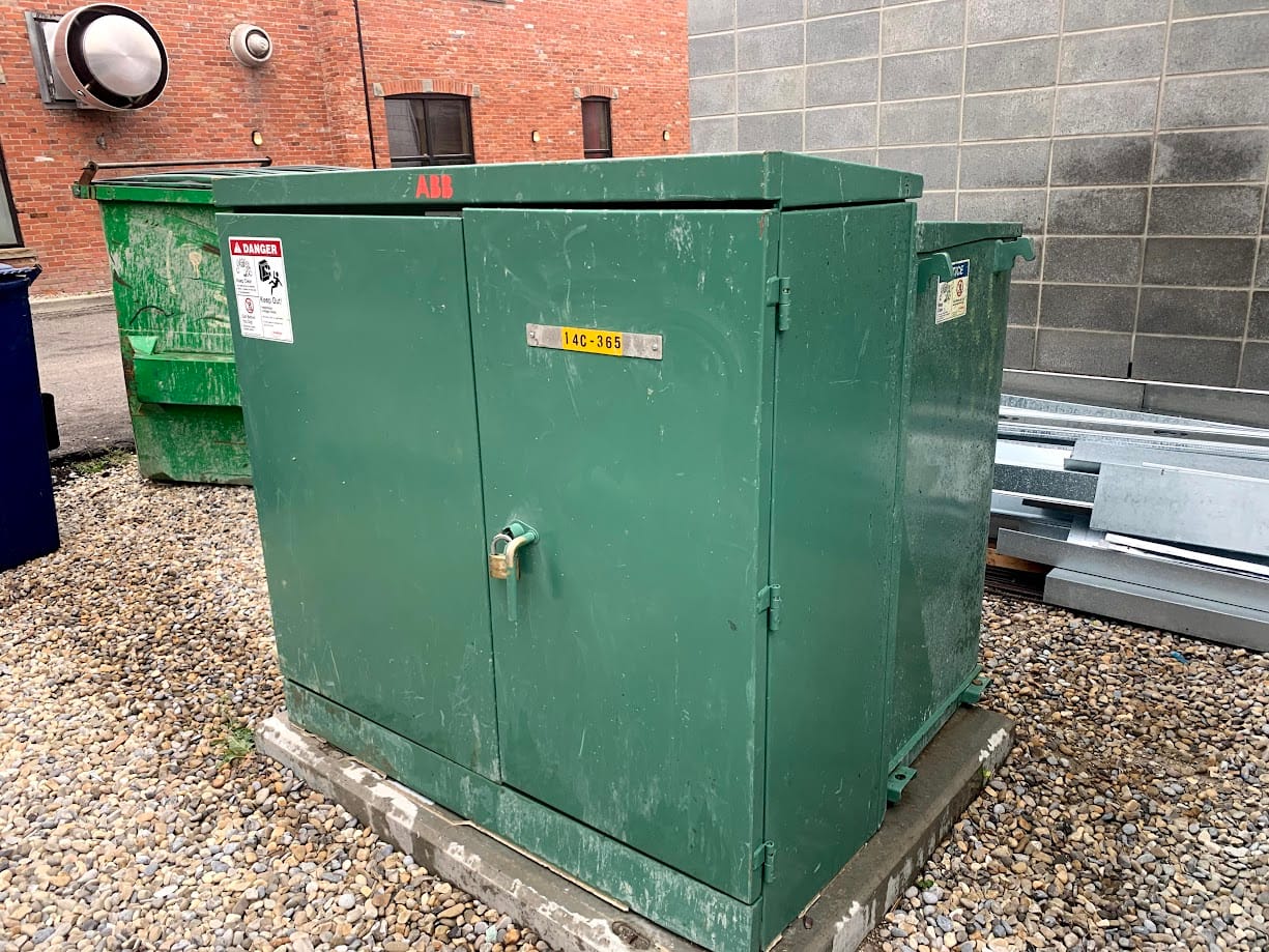 Graffiti removed from dark green electrical box