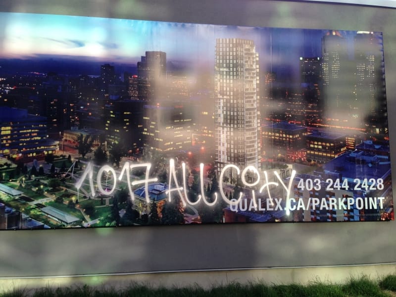 Large Vinyl advert wall graffiti removal Calgary - before